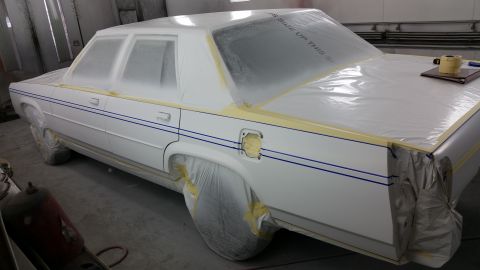 1991 Ford LTD Crown Victoria - Car in a paint booth, covered for prep work.