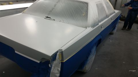 1991 Ford LTD Crown Victoria - Car undergoing paintwork in a workshop, with protective coverings in place.