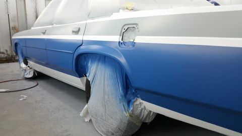 1991 Ford LTD Crown Victoria - A sedan is being prepped for painting in a workshop, with blue and white colors visible.