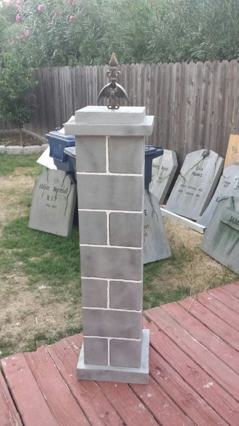 1989 Ford Bronco - A decorative stone pillar stands on a wooden deck, with faux tombstones visible in the background.