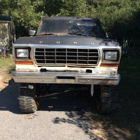 1979 Ford Bronco - Front view of a lifted 1979 Ford Bronco with large tires and a chrome bumper.