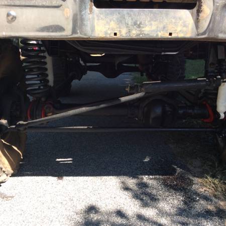1979 Ford Bronco - Close-up view of the vehicle's undercarriage, showing suspension and steering parts.