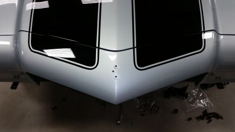 1970 Chevrolet Camaro - The distinctive front end of a 1970 Chevrolet Camaro is shown with racing stripes.