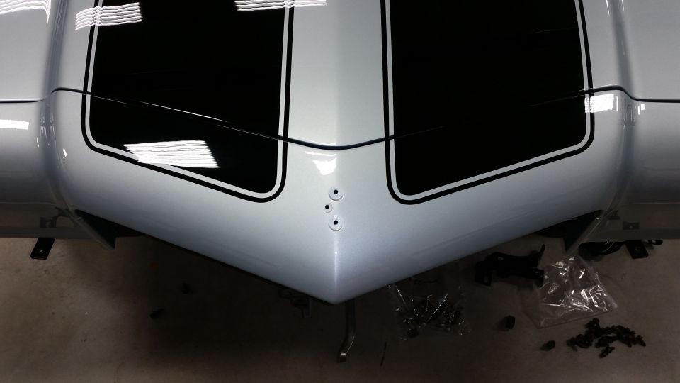 front of a 1970 Chevrolet Camaro with black racing stripes on a silver body