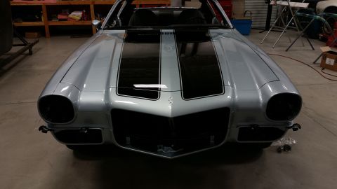 1970 Chevrolet Camaro - The front end of a silver 1970 Chevrolet Camaro is shown with black racing stripes.