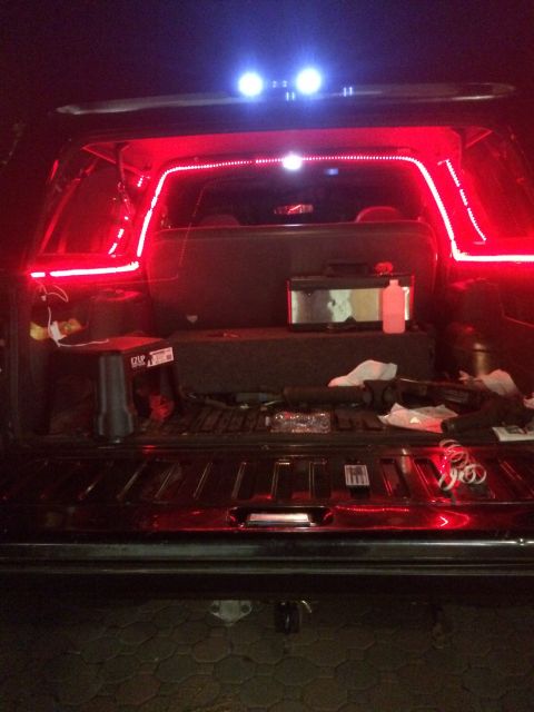 1992 Ford Bronco - The interior of a truck bed is illuminated with red and blue LED strip lights.