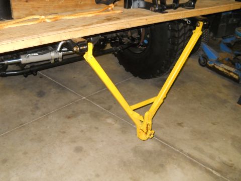 1992 Ford Bronco - Close-up view of a yellow trailer hitch mechanism mounted to a vehicle's frame.