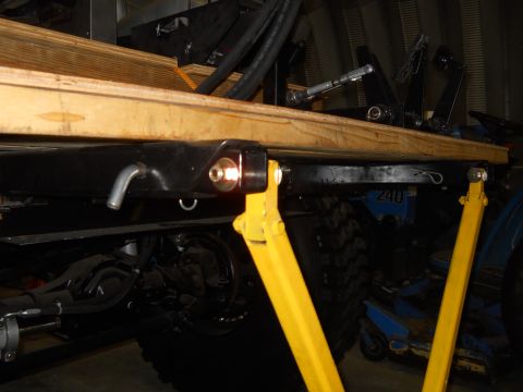 1992 Ford Bronco - Vehicle chassis components are visible, supported by yellow stands.