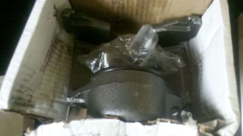 1982 Ford Bronco - A new brake caliper is shown inside its packaging, ready for installation.