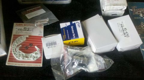 1982 Ford Bronco - A collection of assorted automotive parts, including a turn signal assembly and various boxed components.