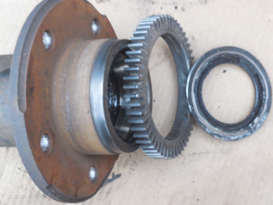 Disassembled wheel hub with ring gear and bearing on concrete