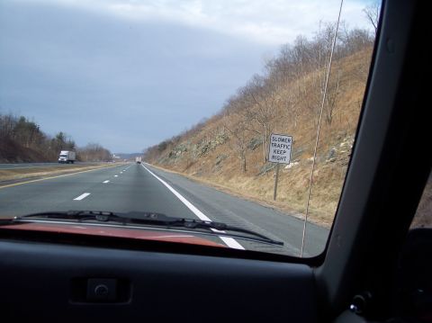 1990 Ford Bronco - Driving on the highway with a sign reminding slower traffic to keep right.