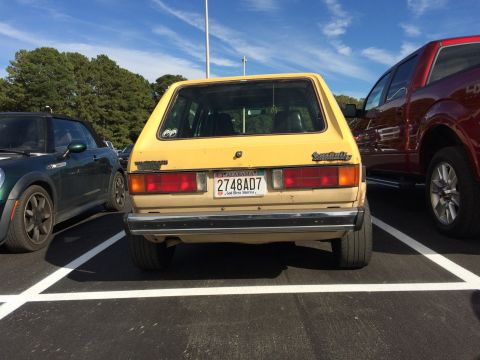 1983 Volkswagen Rabbit - Rear view of a 1983 Volkswagen Rabbit parked in a lot next to other vehicles.