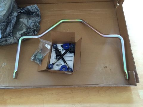 1997 Dodge 3500 - A sway bar kit, including a metal bar and blue bushings, is laid out in a cardboard box.
