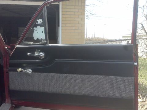 1960 Ford Falcon - The interior door panel features a two-tone design with chrome accents and a patterned fabric insert.