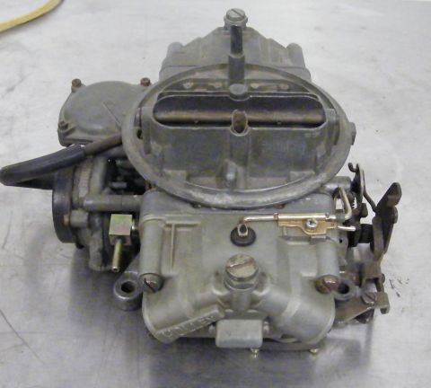 1968 Mercury Cougar - A close-up view of a carburetor, a critical component of a vehicle's fuel system.