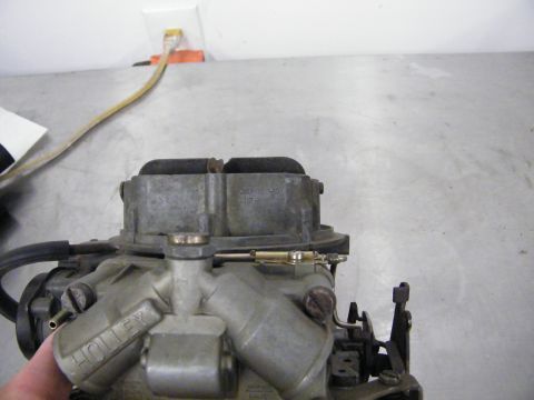 1968 Mercury Cougar - A Holley carburetor is shown with a power cord and outlet visible in the background.
