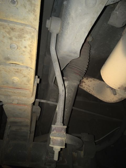 1990 Ford Bronco - Close-up view of the undercarriage, showing suspension linkage and part of the exhaust system.