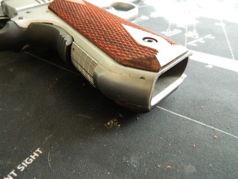 1979 Ford Bronco - A close-up view of a pistol's grip and magazine well, highlighting the textured wood paneling.