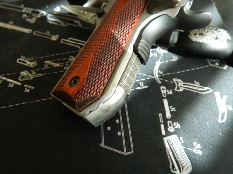 1979 Ford Bronco - Close-up of a pistol grip resting on a mat displaying gun schematics.