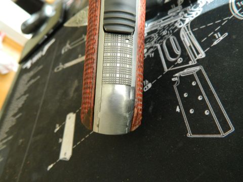 1979 Ford Bronco - Detail of a pistol's grip and slide, set against a diagrammatic background.
