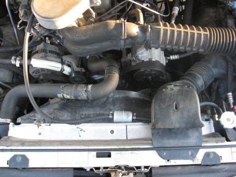 1994 Ford Bronco - Close-up of an engine bay, focusing on the cooling system components and air intake.