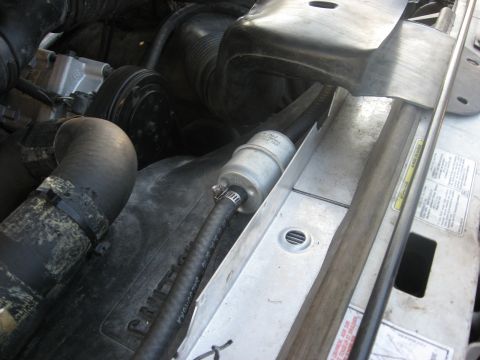 1994 Ford Bronco - Close-up view of engine bay components, including hoses and a filter, with a Supermotors logo in the corner.