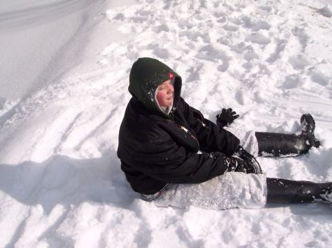 1990 Ford Bronco - A person is sitting in a snowy landscape, wearing winter clothing.
