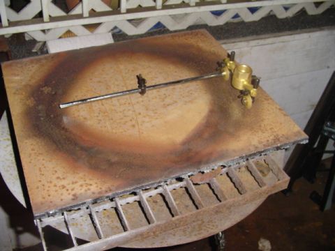 1993 Ford Bronco - A circular cutting guide tool is positioned on a metal plate with heat marks.