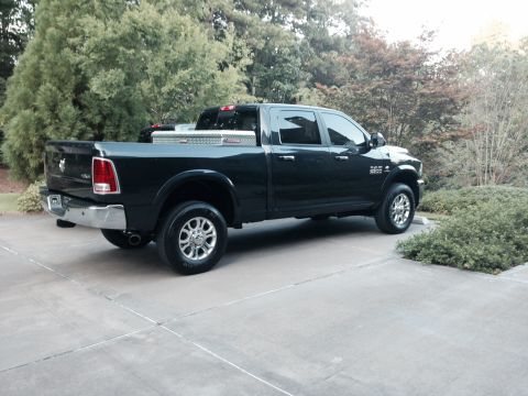 1989 Ford Bronco - This black pickup truck is shown from the rear 3/4 angle, a toolbox mounted in the bed.