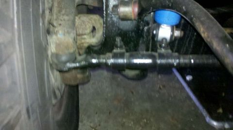 1982 Ford Bronco - Undercarriage view of a vehicle's steering and suspension parts, with visible rust and wear.