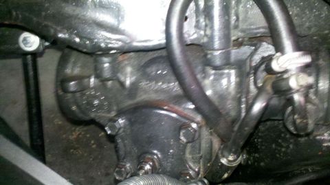 1982 Ford Bronco - Close-up view of a vehicle's power steering gearbox and associated hoses.