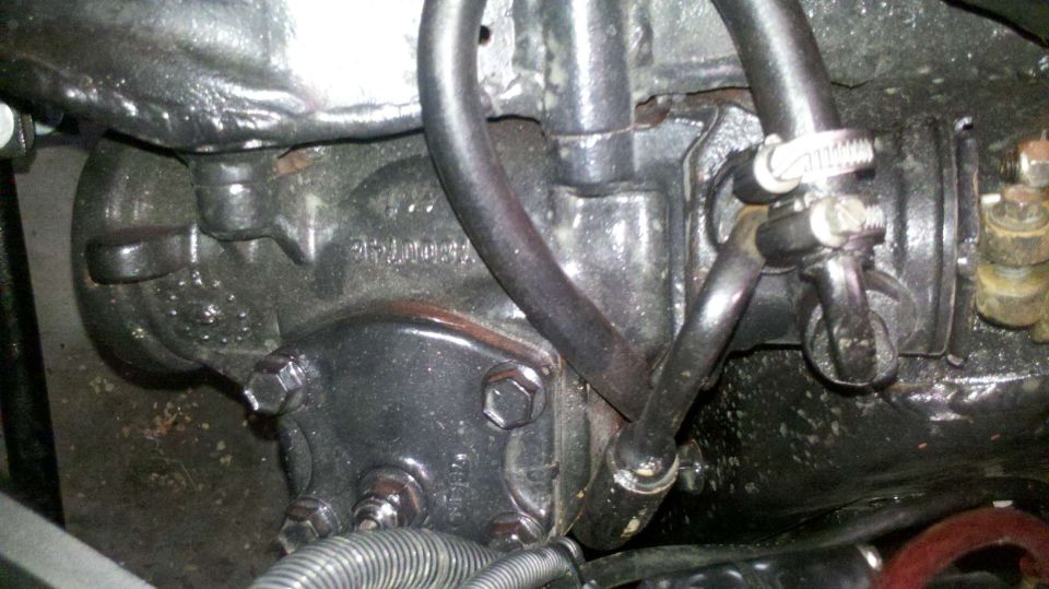 close-up of vehicle's power steering gearbox with hoses attached