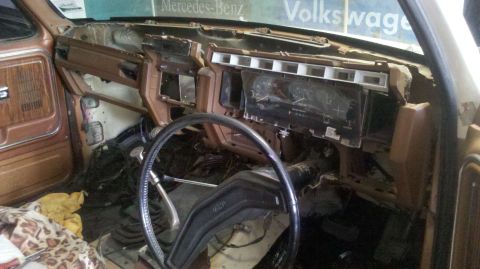 1982 Ford Bronco - The dashboard of this vehicle is in a state of disassembly, revealing exposed wiring and components.