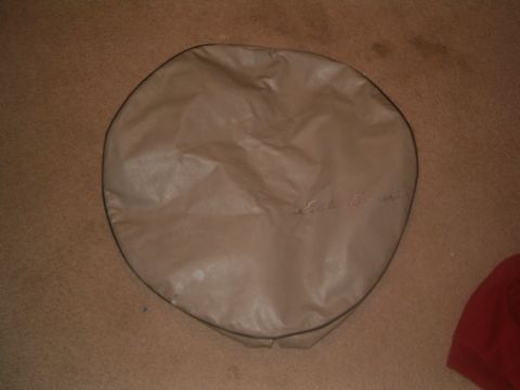 1996 Ford Bronco - A spare tire cover with the Eddie Bauer logo is shown against a carpeted background.