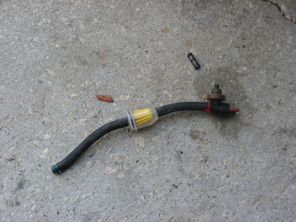 Fuel filter and hose assembly with yellow filter element on concrete