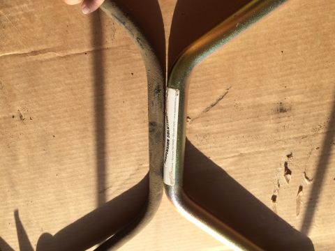 1997 Dodge 3500 - Comparison of a used sway bar with a new gold-coated replacement part.