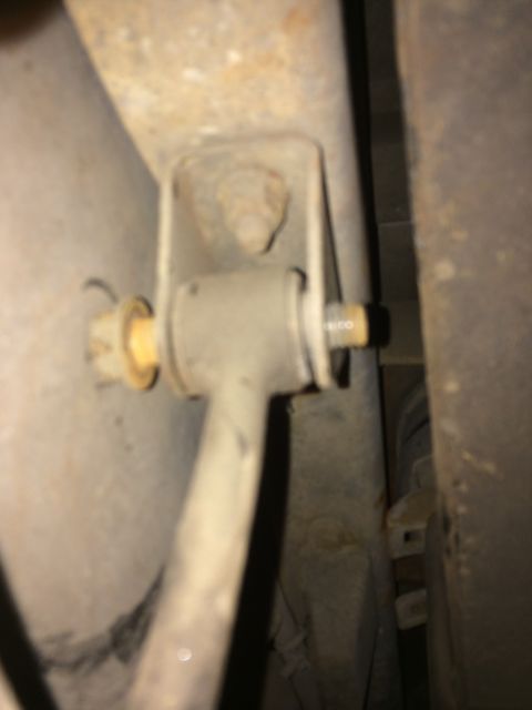 1997 Dodge 3500 - Close-up view of a sway bar link and its mounting bracket on a vehicle's undercarriage.