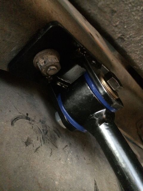 1997 Dodge 3500 - Close-up view of a sway bar assembly blue polyurethane bushings and a black mounting bracket.