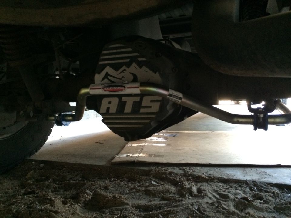 Underneath a vehicle showing the rear differential cover with ATS branding and a sway bar installed
