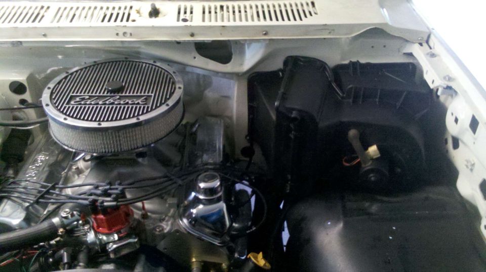 Engine bay with an Edelbrock air cleaner and chrome valve covers