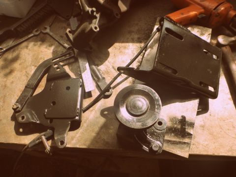 1964 Mercury Monterey - Various automotive parts and tools are laid out on a workbench, with a drill visible in the background.