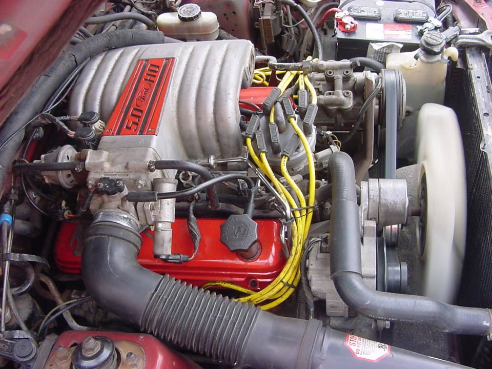 Ford 5.0 HO V8 engine bay with red valve covers and yellow spark plug wires