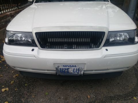 2000 Mercury Grand Marquis - Front view of a white 2000 Mercury Grand Marquis, displaying its grille and Nevada license plate.