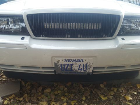 2000 Mercury Grand Marquis - Front view of a white 2000 Mercury Grand Marquis, a black grille with an integrated LED light bar and a Nevada license plate.