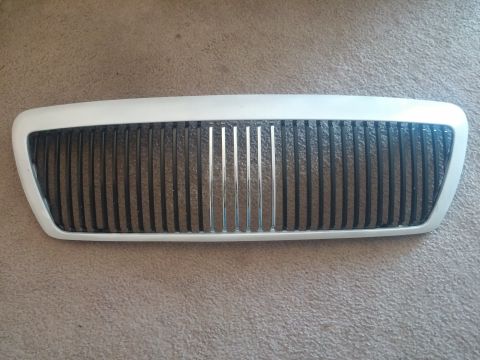 2000 Mercury Grand Marquis - A close-up view of a vehicle's front grille, showing its distinct vertical bar design.