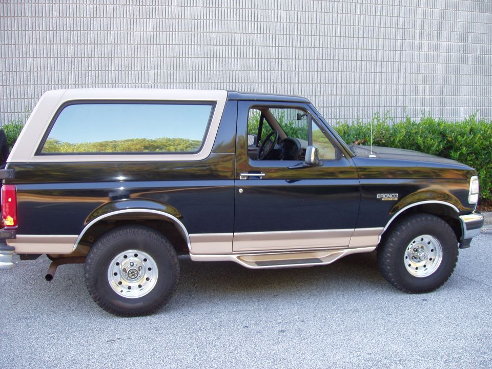 Side view of a 1996 Ford Bronco with a tan top and tan lower trim