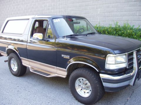 1996 Ford Bronco - This 1996 Ford Bronco is shown from a 3/4 front angle, highlighting its two-tone paint and chrome accents.