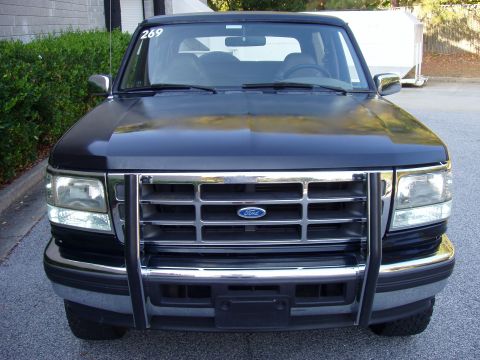 1996 Ford Bronco - Front view of a black 1996 Ford Bronco, a chrome grille and a protective bull bar.