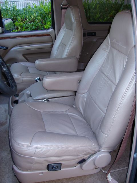 1996 Ford Bronco - Interior view of a 1996 Ford Bronco, highlighting the tan leather seats and armrests.